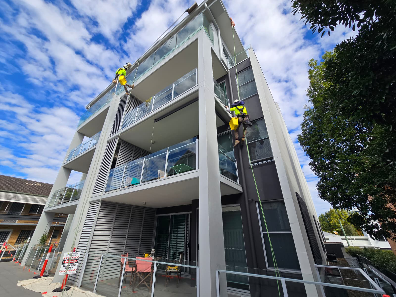 Water damage on a commercial building wall before repainting in Brisbane